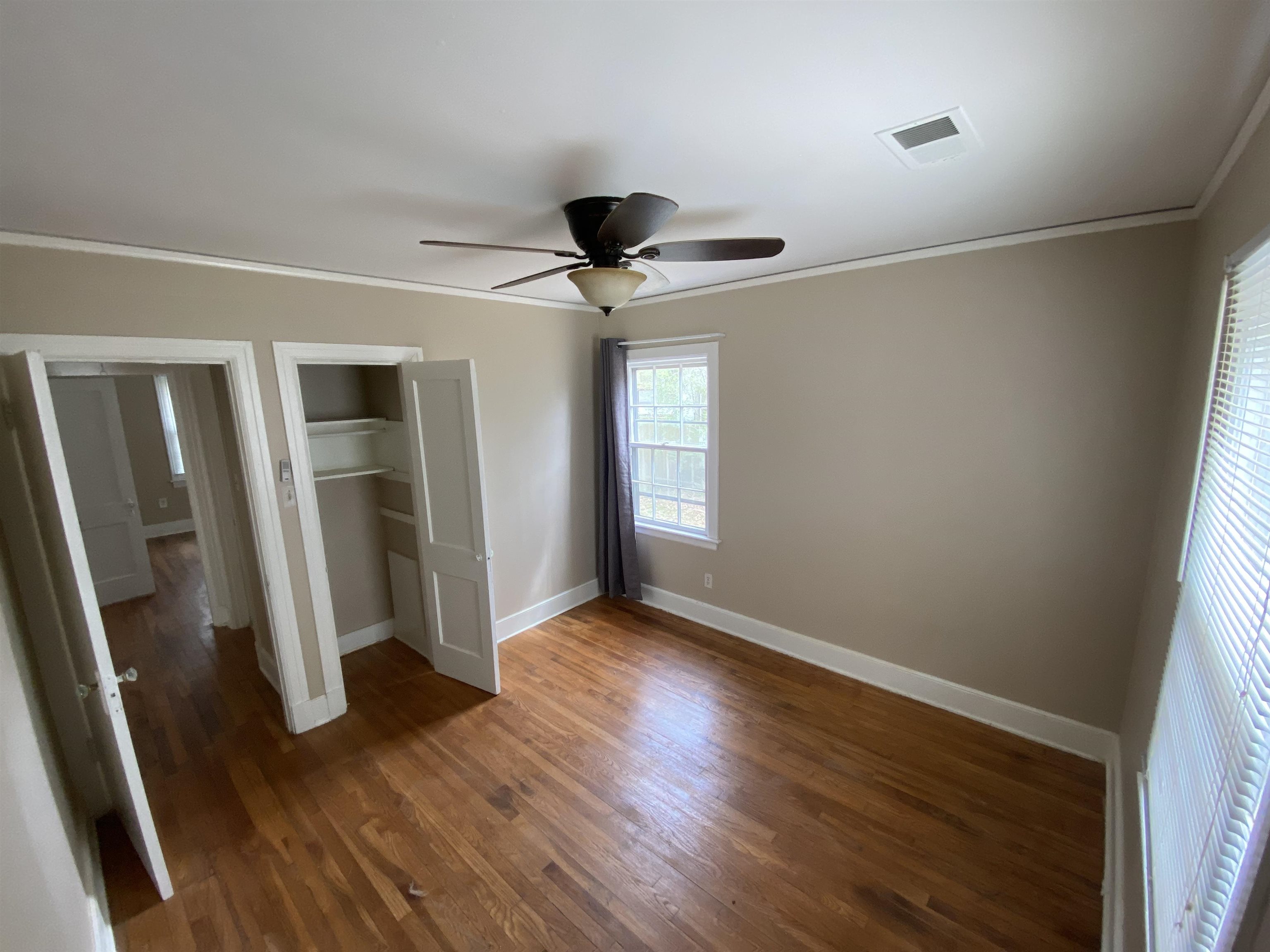 648 Loeb Street Memphis, TN 38111 - Photo 13 of 18 a view of an empty room with wooden floor and a window