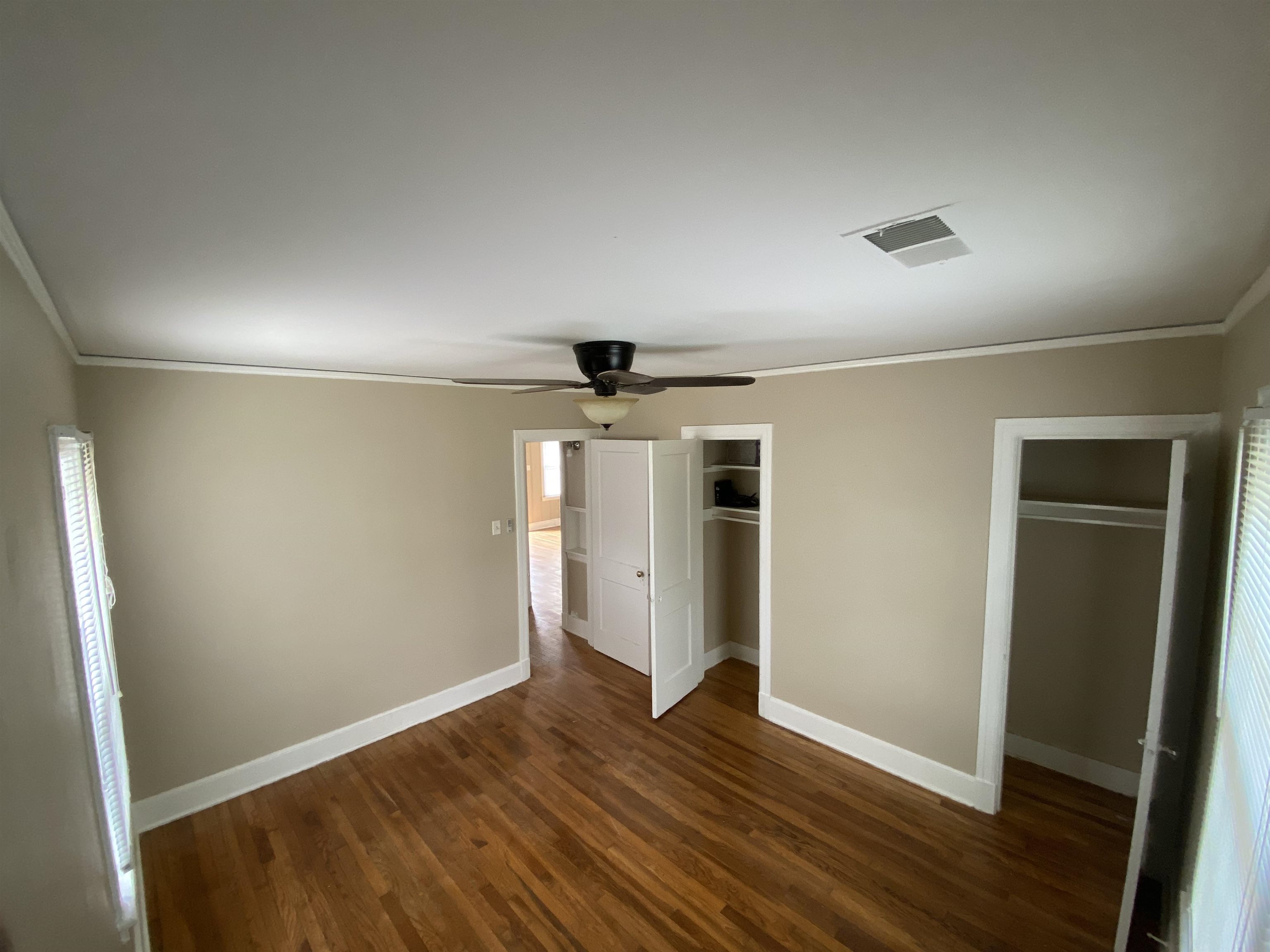 648 Loeb Street Memphis, TN 38111 - Photo 7 of 18 an empty room with wooden floor and windows