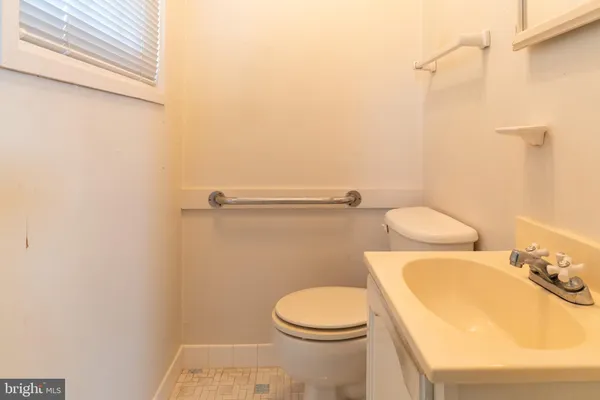a white toilet sitting next to a bathroom sink