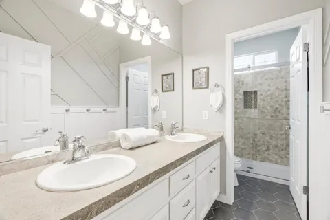 a bathroom with a double vanity sink and a mirror