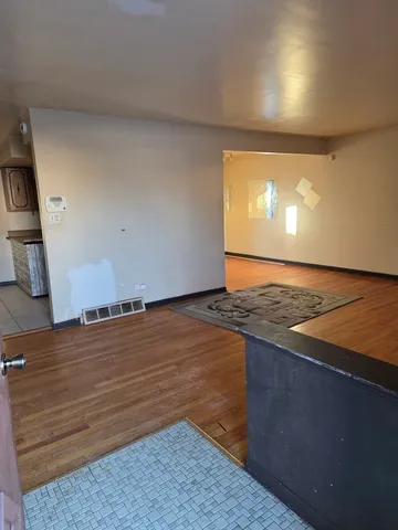 a view of an empty room and wooden floor