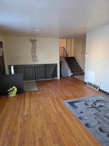 a view of staircase and hall with wooden floor