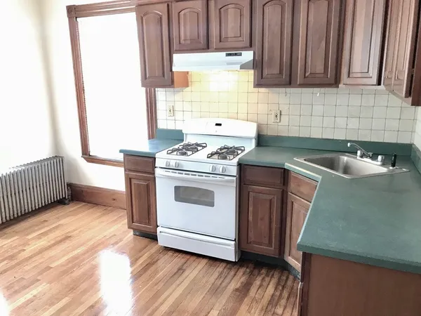 a kitchen that has a sink and a stove