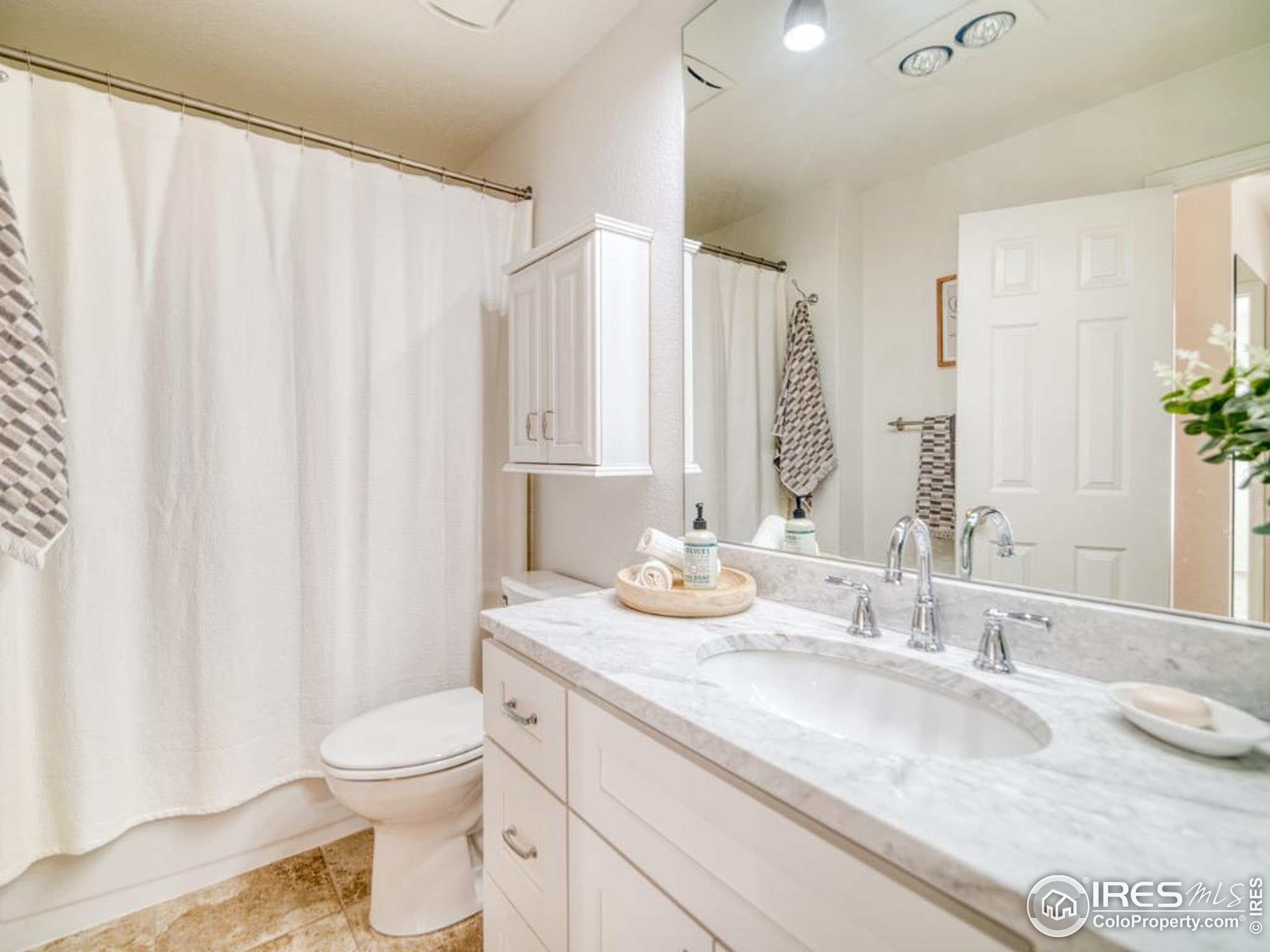 5174 Buckingham Road Boulder, CO 80301 - Photo 14 of 29 a bathroom with a granite countertop sink and a mirror