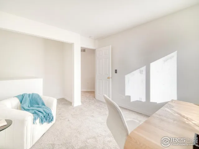 a view of a bedroom with furniture and closet