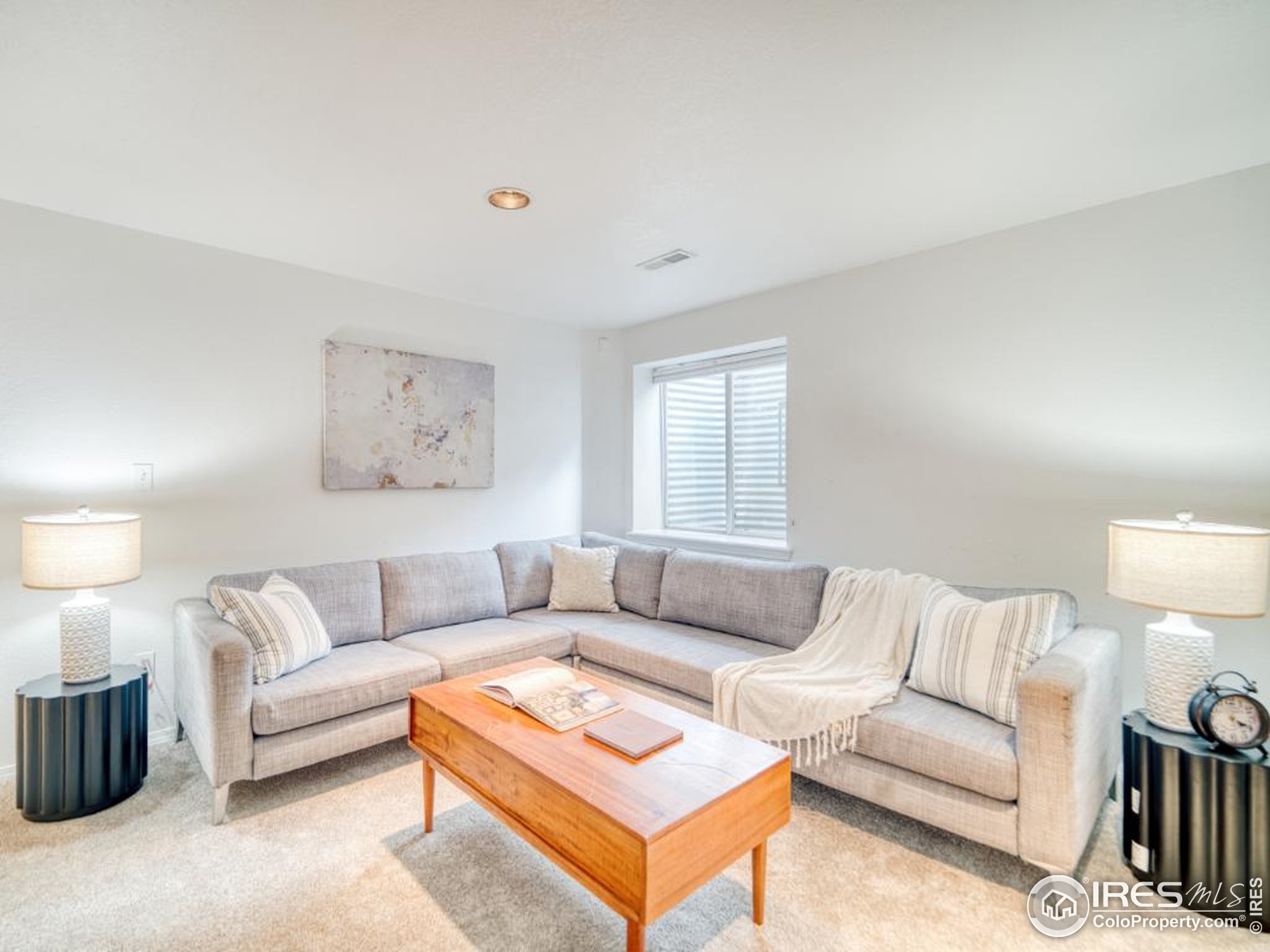 5174 Buckingham Road Boulder, CO 80301 - Photo 19 of 29 a living room with furniture a lamp and a table