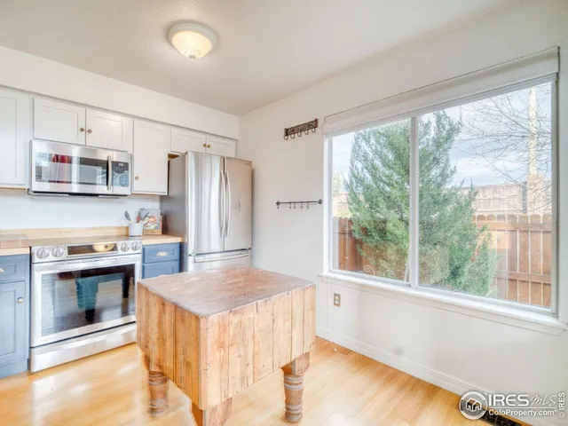 a kitchen with kitchen island a sink stove and refrigerator