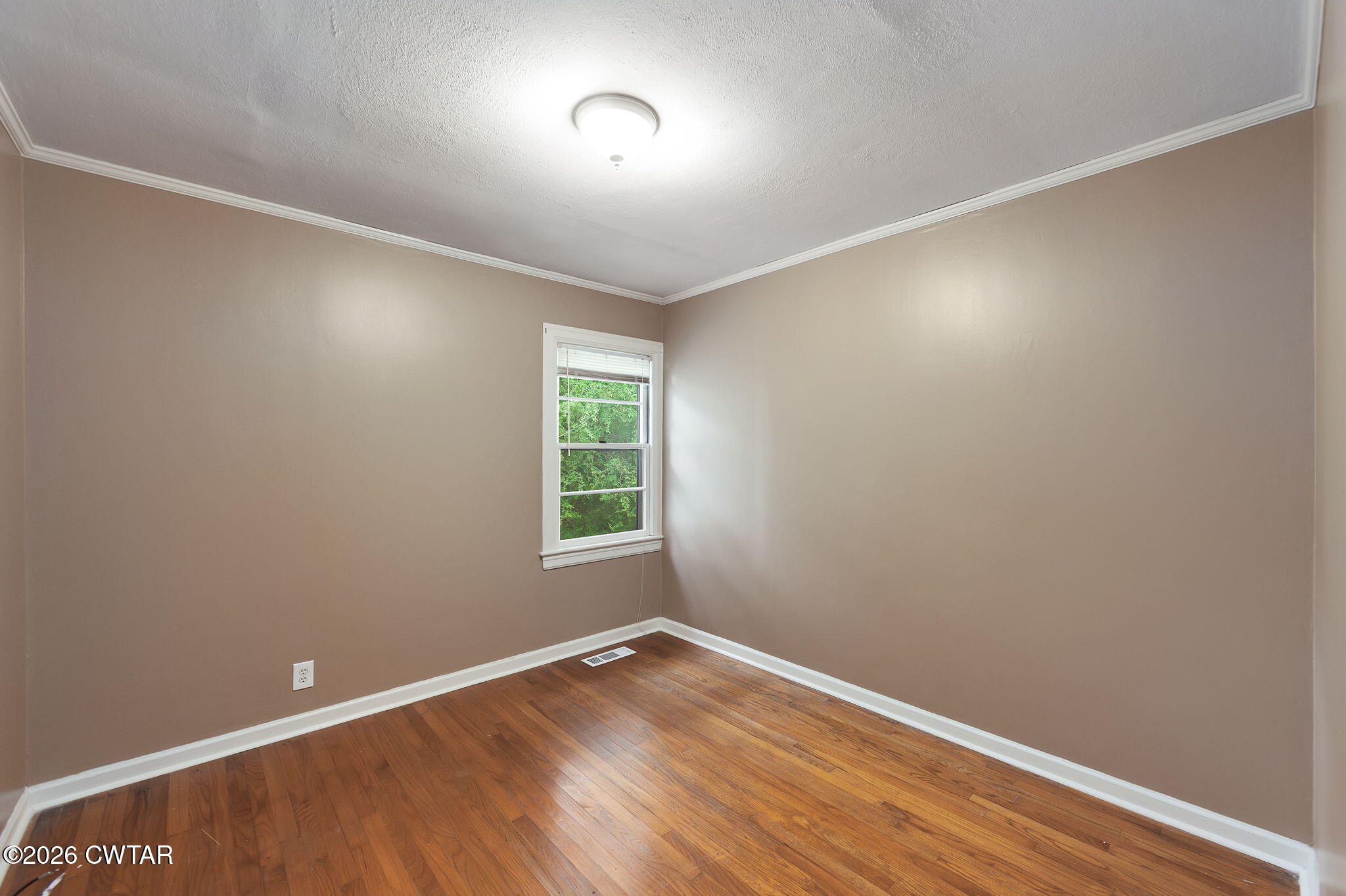 118 Radio Road Jackson, TN 38301 - Photo 17 of 22 an empty room with wooden floor and windows