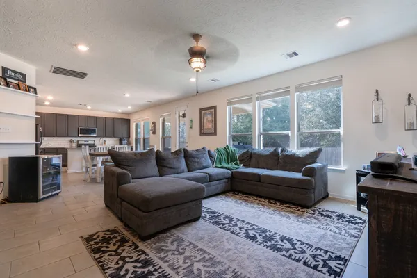 a living room with furniture and a large window
