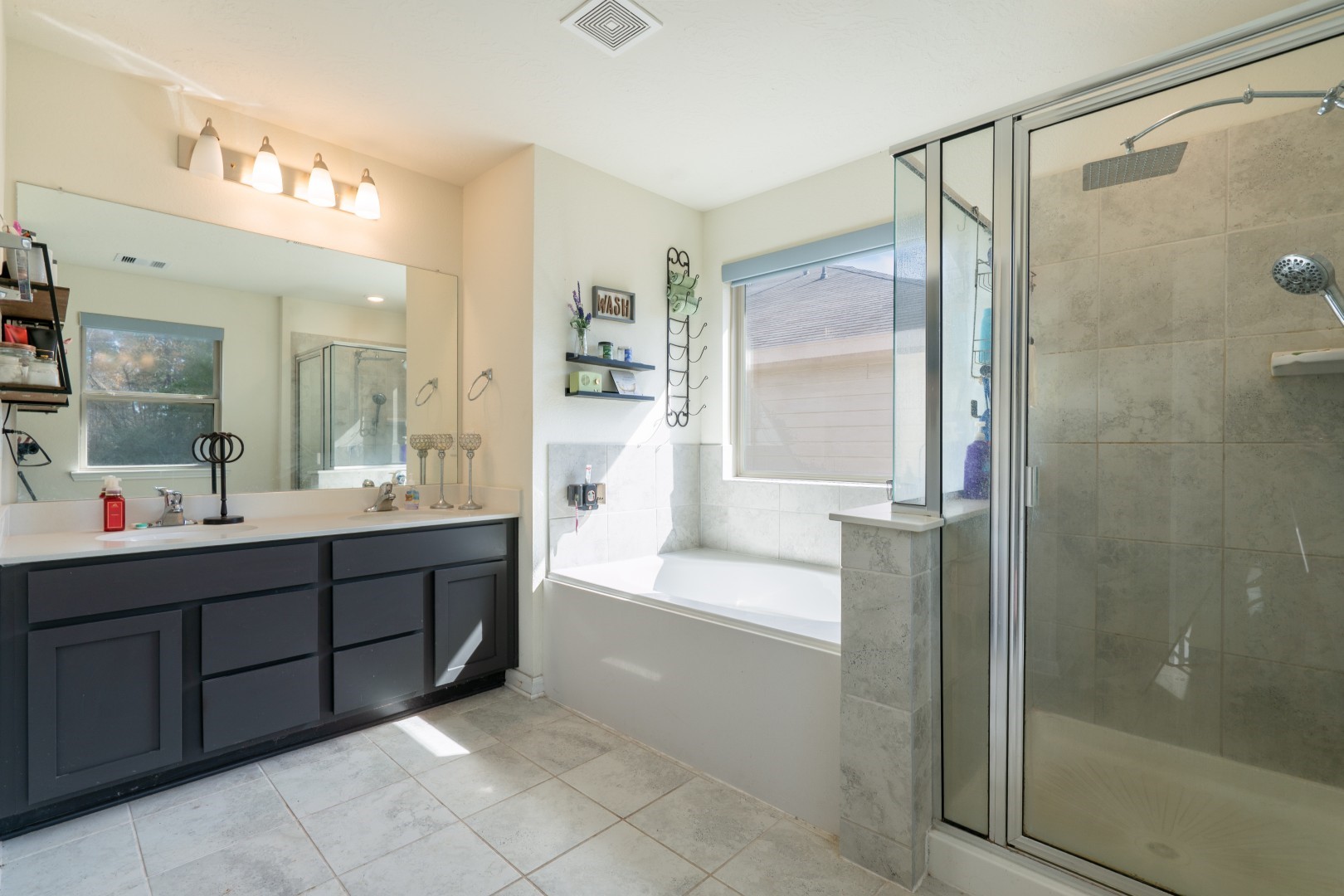 2003 Parnevik Place Conroe, TX 77304 - Photo 16 of 28 a bathroom with a tub a sink shower and mirror