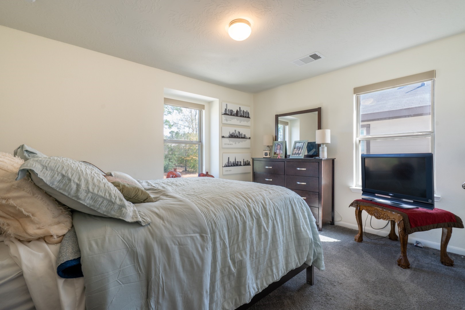 2003 Parnevik Place Conroe, TX 77304 - Photo 19 of 28 a bedroom with a bed and a flat screen tv