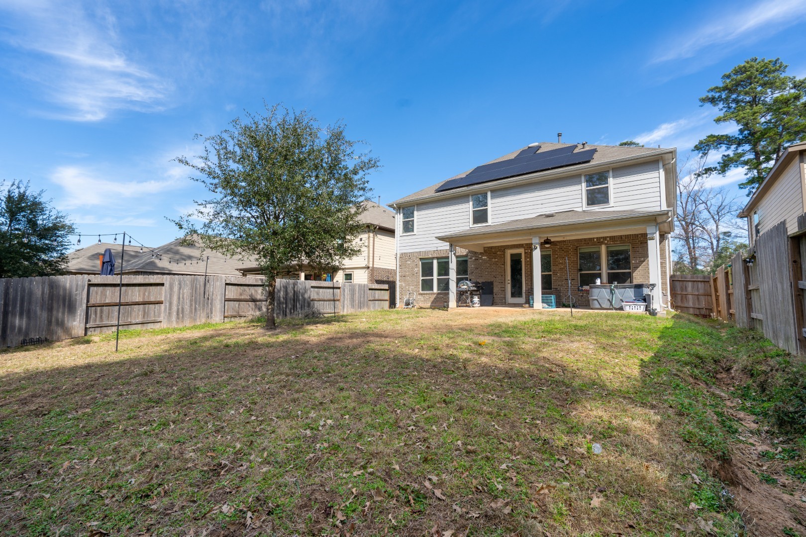 2003 Parnevik Place Conroe, TX 77304 - Photo 26 of 28 a front view of a house with a yard