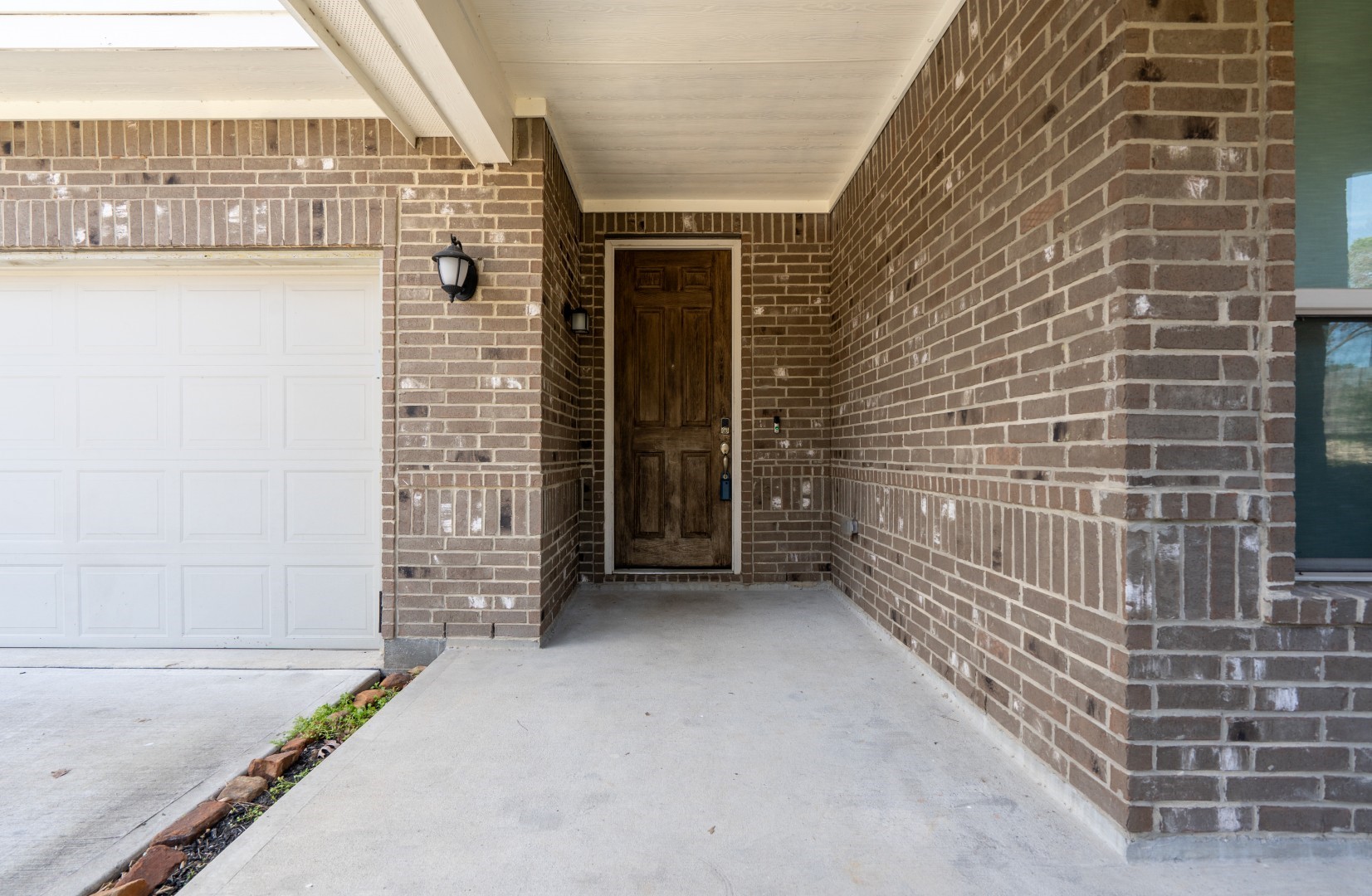 2003 Parnevik Place Conroe, TX 77304 - Photo 4 of 28 a view of a brick house with glass windows