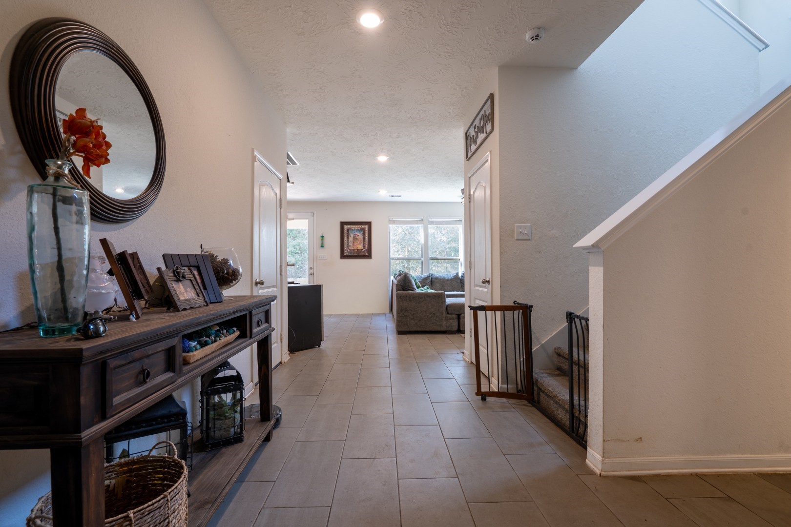 2003 Parnevik Place Conroe, TX 77304 - Photo 6 of 28 a living room with furniture a mirror and a flat screen tv