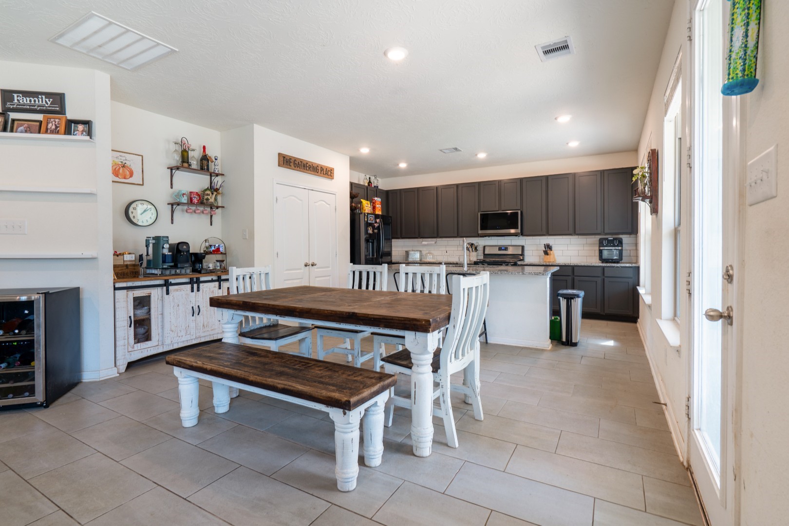 2003 Parnevik Place Conroe, TX 77304 - Photo 10 of 28 a kitchen with stainless steel appliances kitchen island granite countertop a refrigerator and a stove top oven