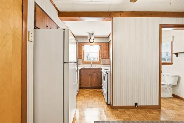 a kitchen with a sink a stove a microwave and cabinets