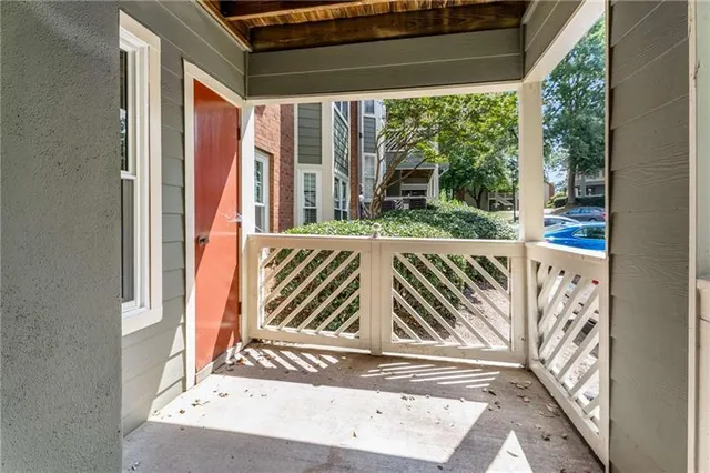 a view of balcony with wooden floor and fence