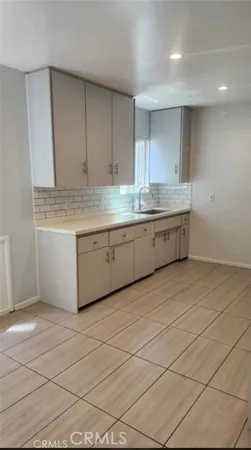 a kitchen with granite countertop a sink cabinets and window