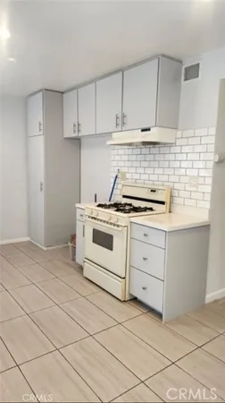 a kitchen with cabinets appliances and a sink