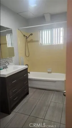 a bathroom with a bathtub and a sink