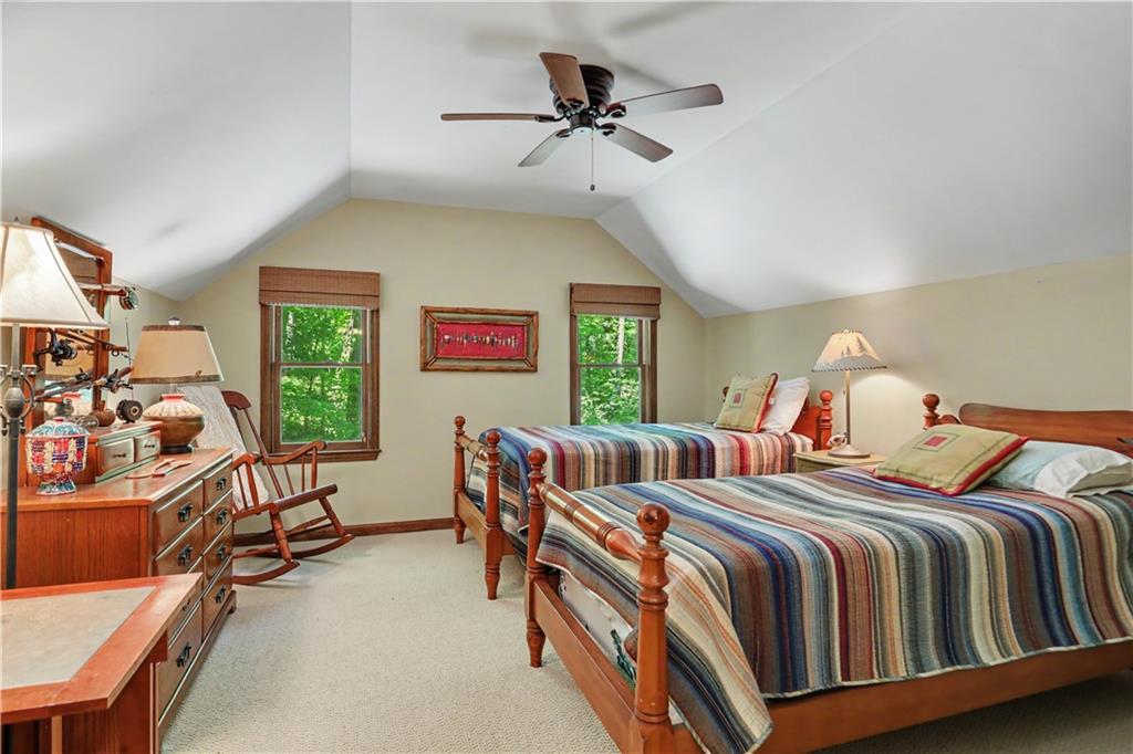 102 Moses Road Rabun Gap, GA 30568 - Photo 22 of 40 a bedroom with two beds and a chandelier