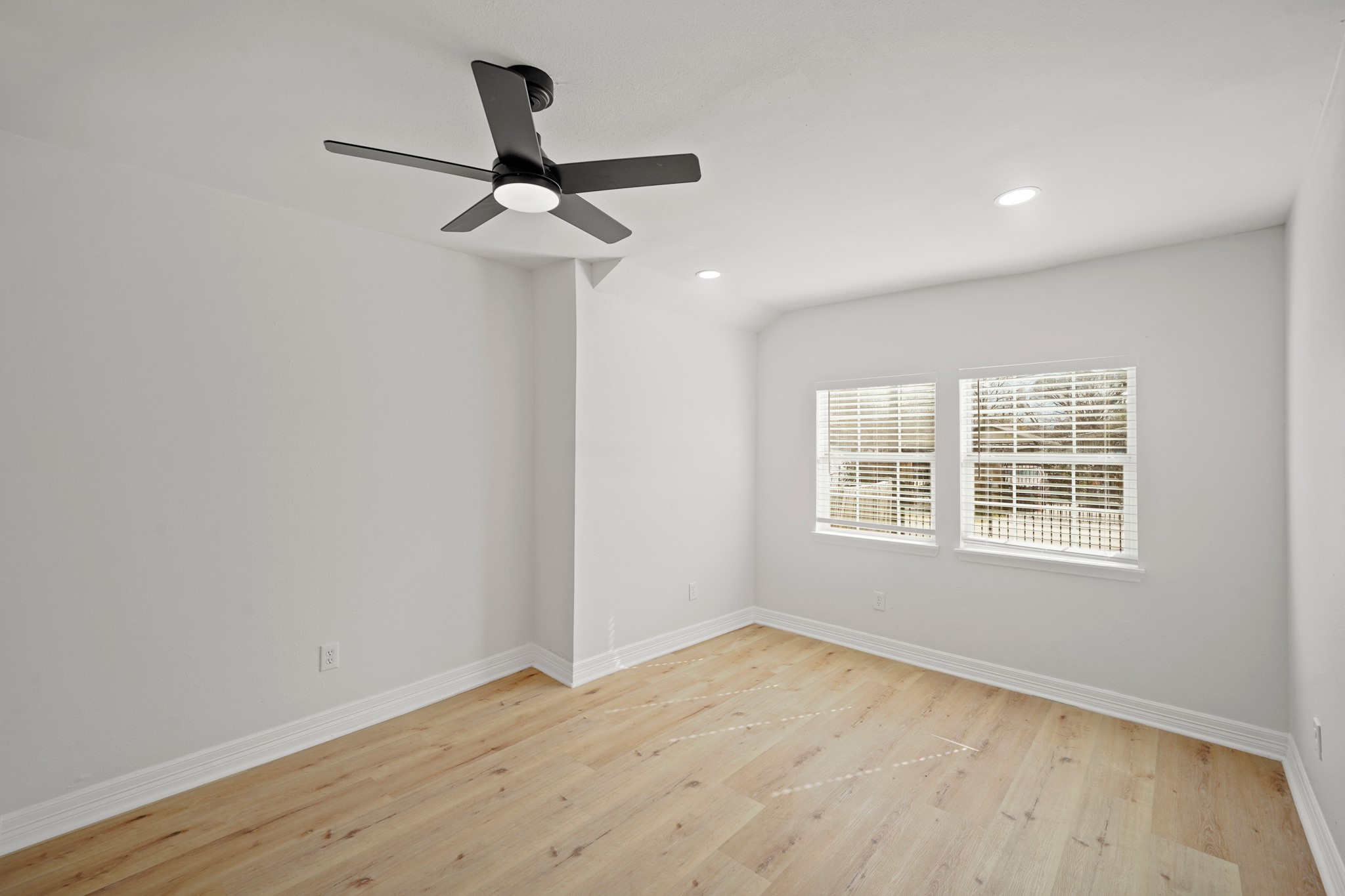 3501 Farmer Street Houston, TX 77020 - Photo 11 of 27 an empty room with wooden floor ceiling fan and windows