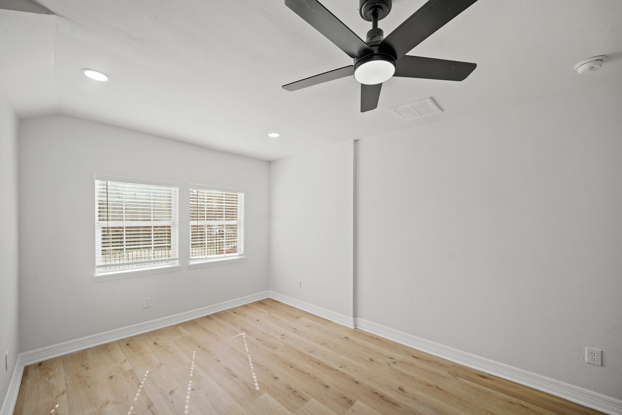 3501 Farmer Street Houston, TX 77020 - Photo 12 of 27 an empty room with wooden floor fan and windows