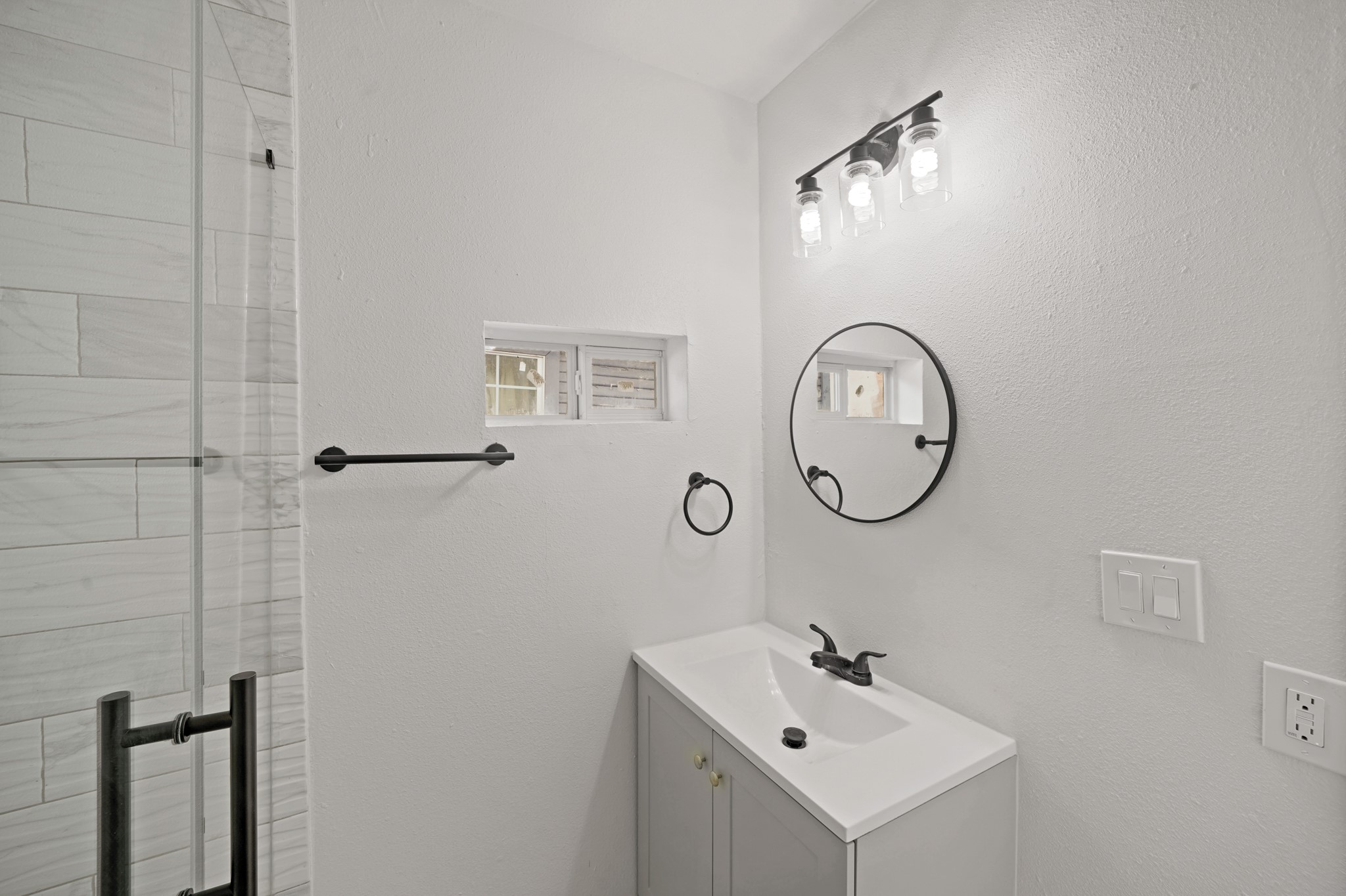 3501 Farmer Street Houston, TX 77020 - Photo 18 of 27 a bathroom with a sink a mirror and a shower