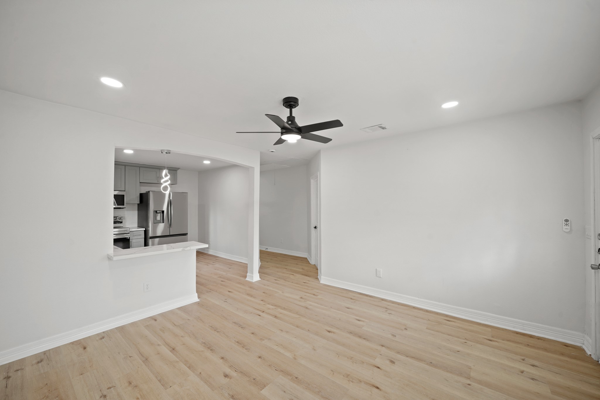 3501 Farmer Street Houston, TX 77020 - Photo 6 of 27 a view of a livingroom with wooden floor and a ceiling fan
