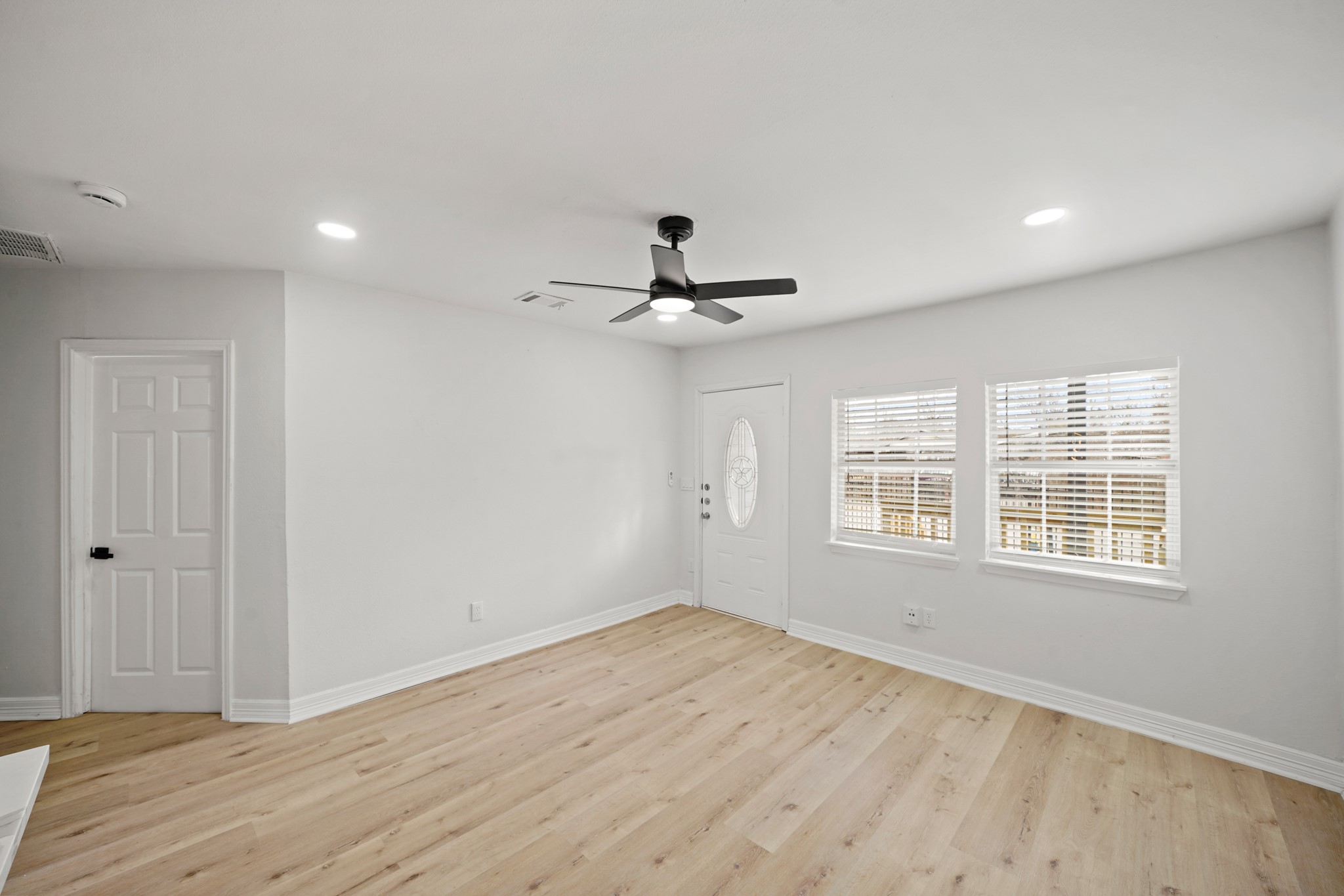 3501 Farmer Street Houston, TX 77020 - Photo 7 of 27 a view of empty room with wooden floor and fan