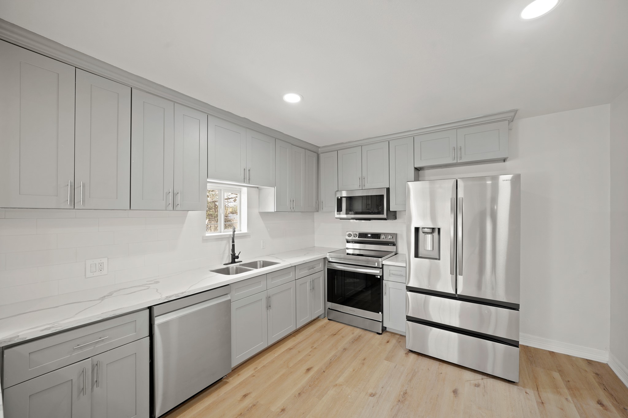 3501 Farmer Street Houston, TX 77020 - Photo 9 of 27 a kitchen with stainless steel appliances granite countertop a sink stove and refrigerator