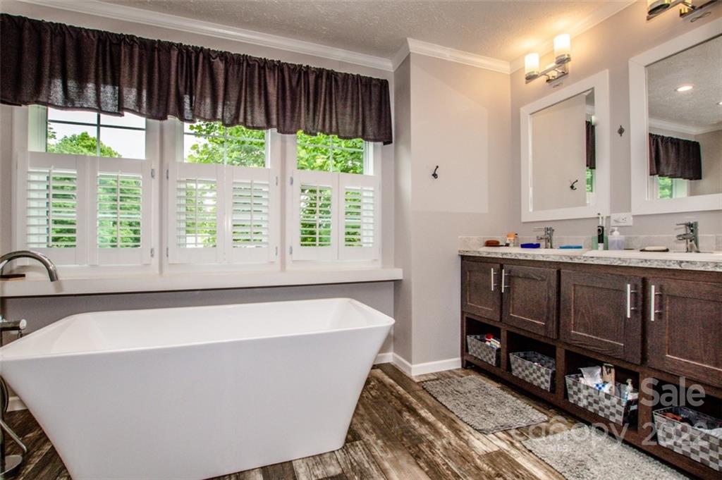 170 Houpe Road Cleveland, NC 27013 - Photo 36 of 48 a bath tub sitting in a bathroom next to a window