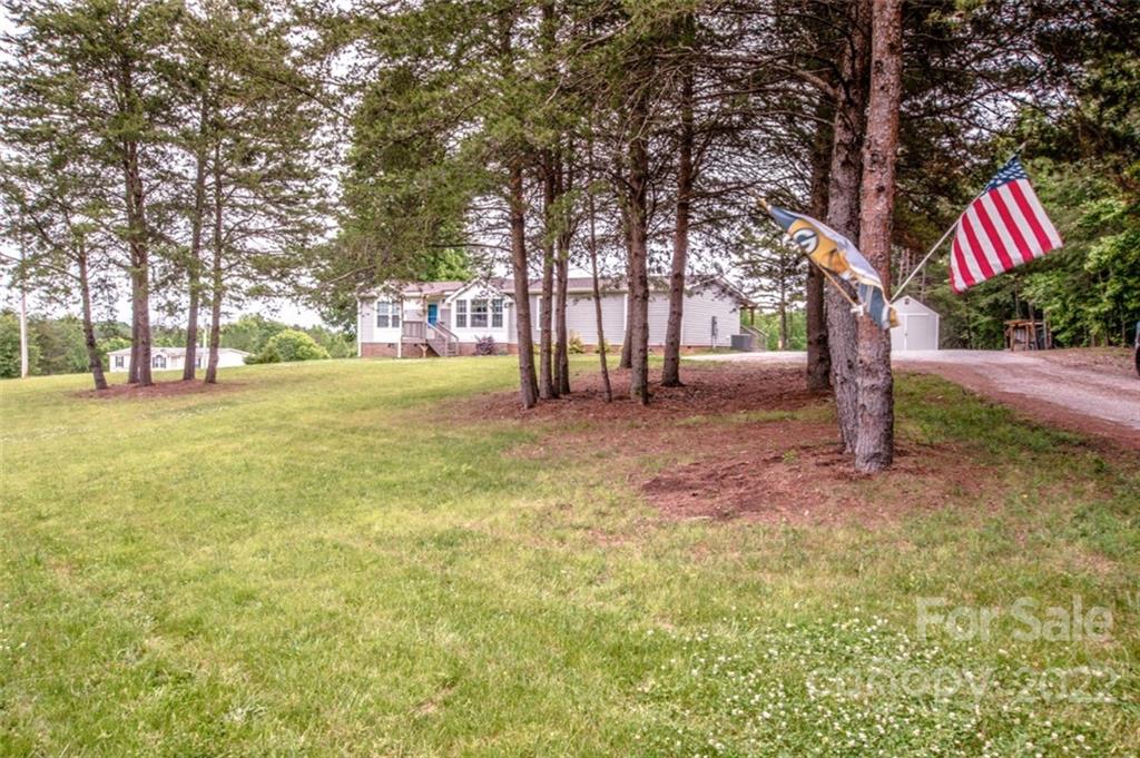 170 Houpe Road Cleveland, NC 27013 - Photo 4 of 48 a backyard of a house with lots of green space and fountain