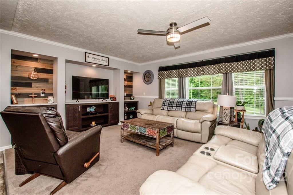 170 Houpe Road Cleveland, NC 27013 - Photo 42 of 48 a living room with furniture ceiling fan and a flat screen tv
