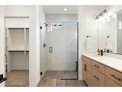 a bathroom with a shower sink and mirror