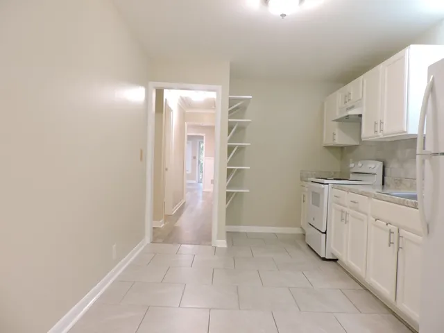 a view of a kitchen with white cabinets