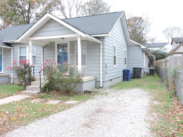 a view of a house with a yard and plants