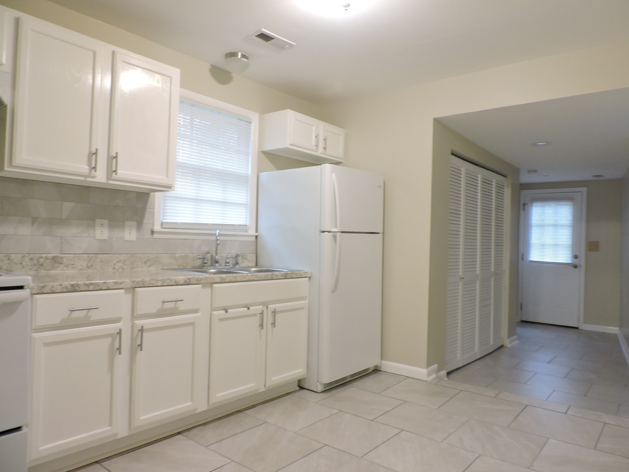 355 9th Avenue North, Unit B Franklin, TN 37064 - Photo 10 of 21 a kitchen with white cabinets and refrigerator