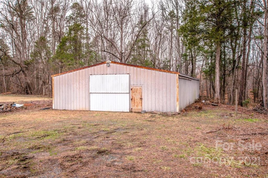 255 Rock Hump Road Salisbury, NC 28147 - Photo 21 of 39 a view of backyard with large trees and wooden fence