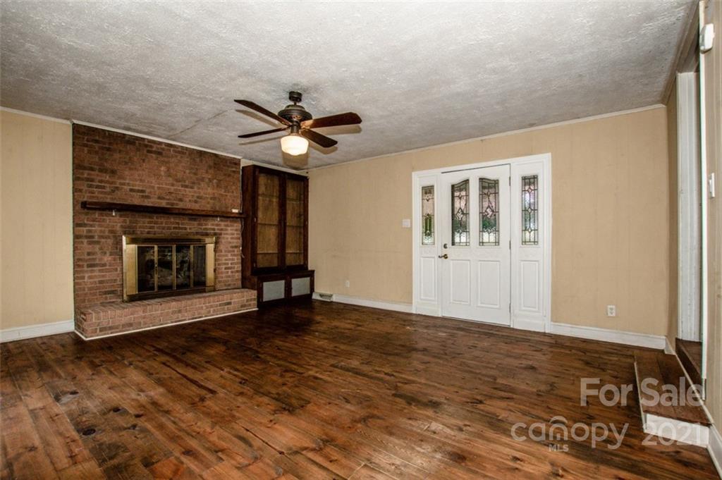 255 Rock Hump Road Salisbury, NC 28147 - Photo 24 of 39 a view of an empty room with a fireplace and a window