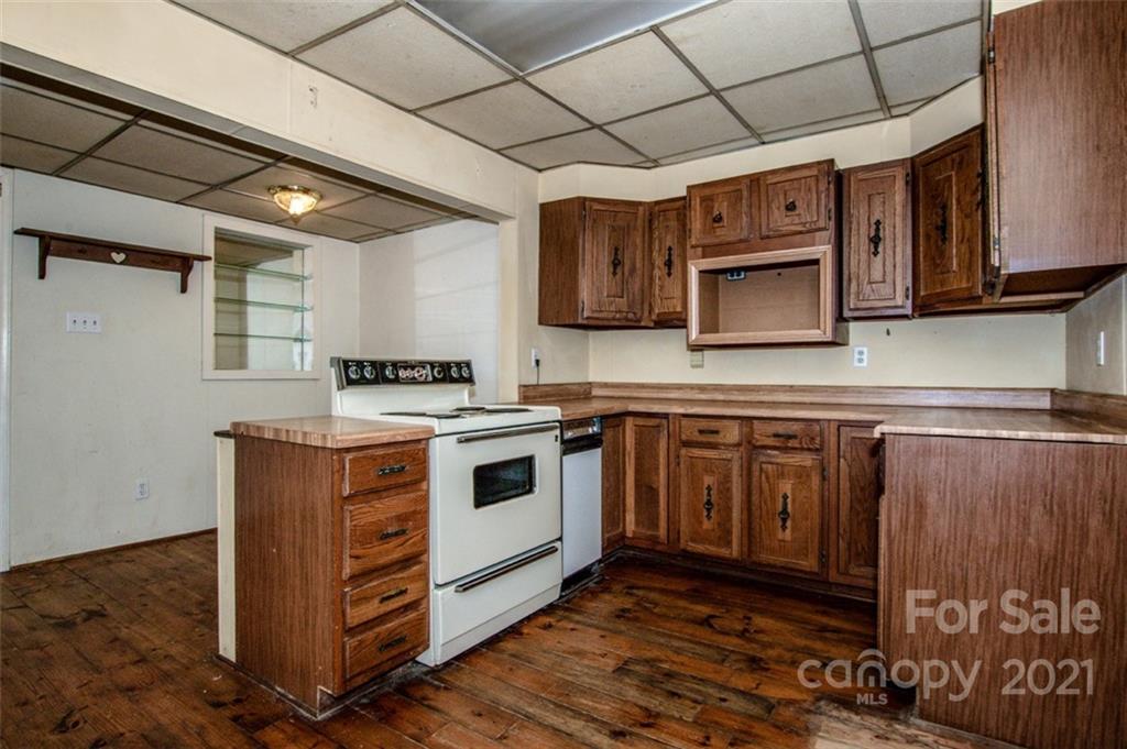 255 Rock Hump Road Salisbury, NC 28147 - Photo 29 of 39 a kitchen with granite countertop a stove top oven microwave and cabinets