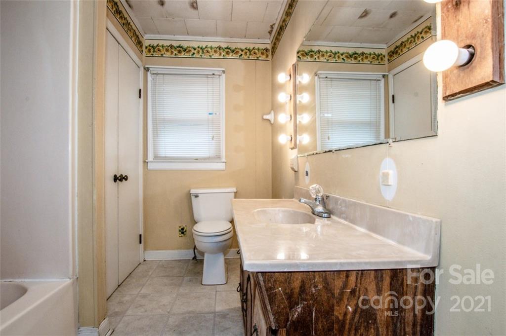 255 Rock Hump Road Salisbury, NC 28147 - Photo 33 of 39 a bathroom with a sink a toilet and a mirror
