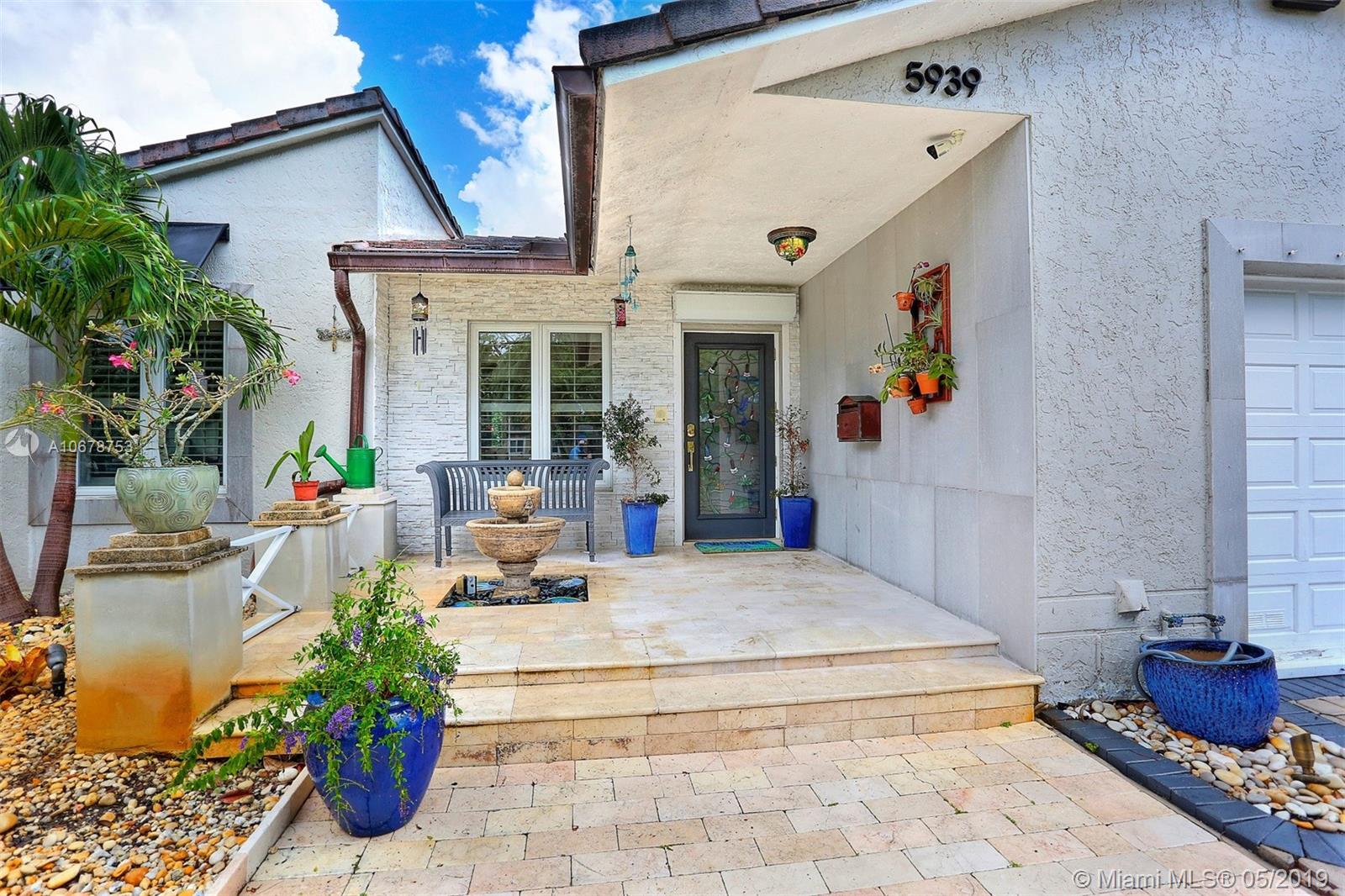 5939 Southwest 34th Street Miami, FL 33155 - Photo 2 of 30 Impeccably-designed 3-bedroom home in Schenley Park with an updated kitchen, bright open spaces, vaulted ceilings, large impact-resistant windows, bountiful storage space and enjoyable exterior spaces.