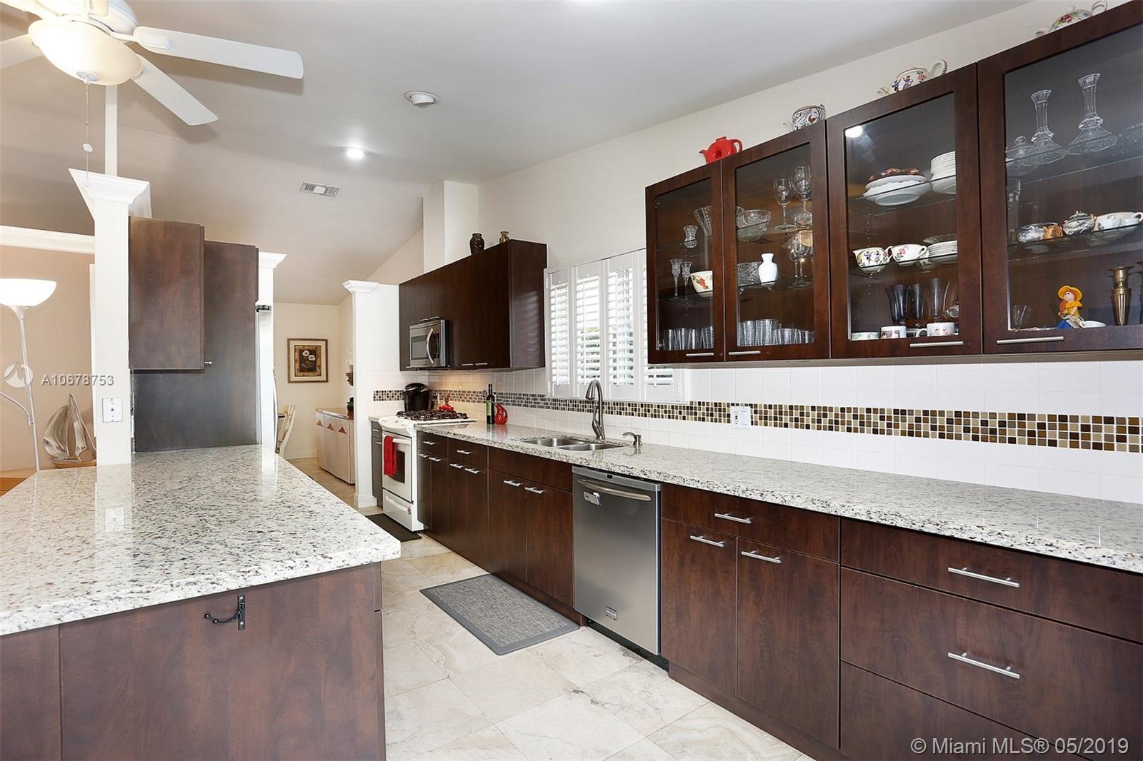 5939 Southwest 34th Street Miami, FL 33155 - Photo 11 of 30 Do you love to cook and entertain? This updated eat-in kitchen with a gas range allows you to do both with plenty of space to prep and execute your favorite dishes while entertaining guests in the family room, living room, dining room AND courtyard.
