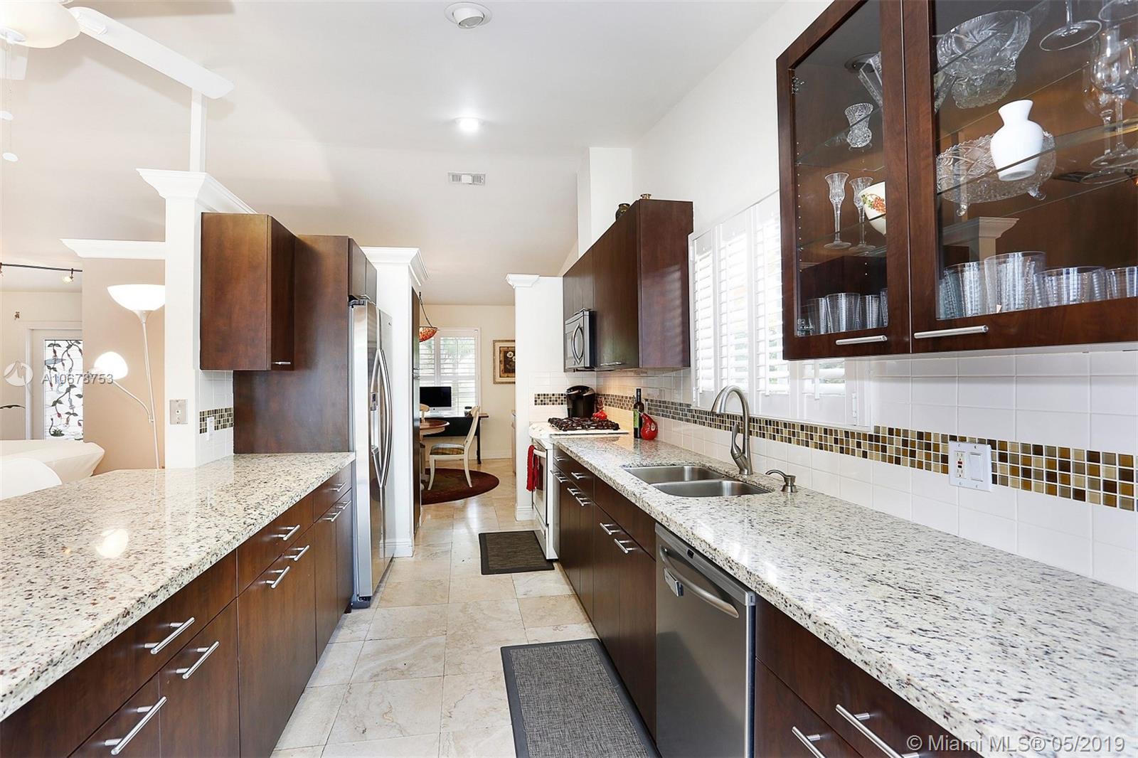 5939 Southwest 34th Street Miami, FL 33155 - Photo 12 of 30 Do you love to cook and entertain? This updated eat-in kitchen with a gas range allows you to do both with plenty of space to prep and execute your favorite dishes while entertaining guests in the family room, living room, dining room AND courtyard.