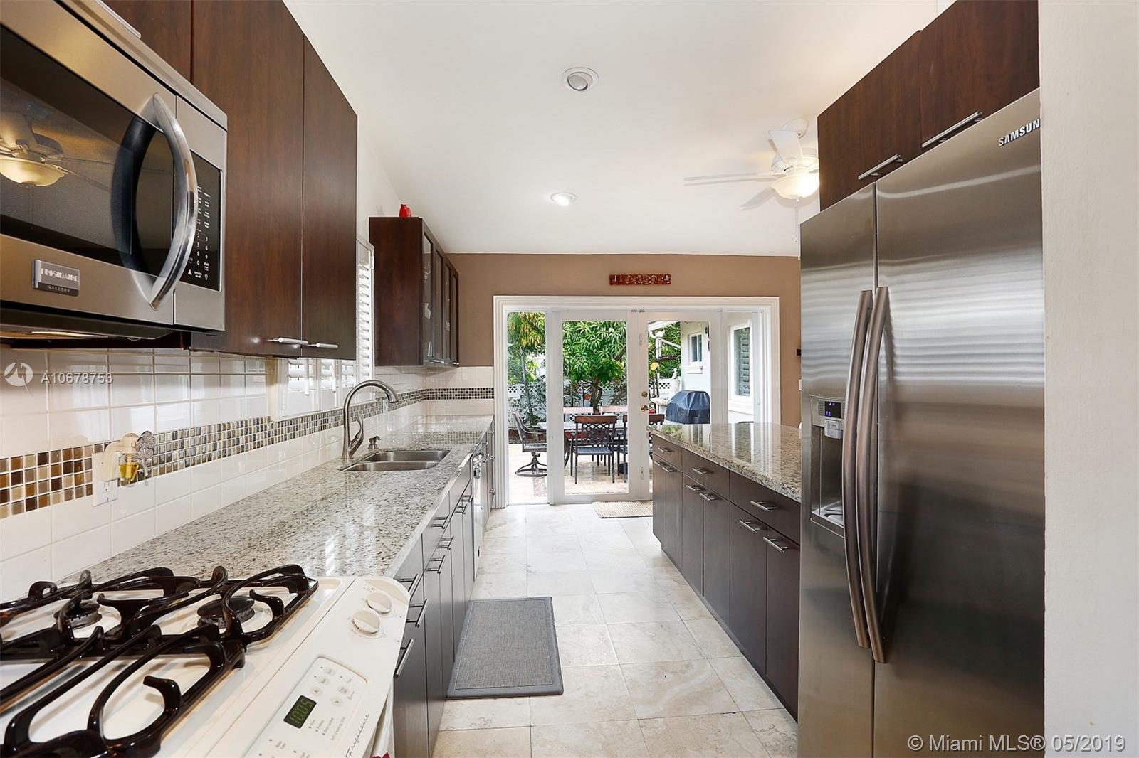 5939 Southwest 34th Street Miami, FL 33155 - Photo 13 of 30 Do you love to cook and entertain? This updated eat-in kitchen with a gas range allows you to do both with plenty of space to prep and execute your favorite dishes while entertaining guests in the family room, living room, dining room AND courtyard.