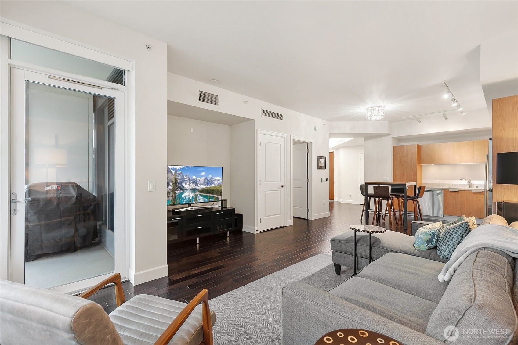 1920 4th Avenue, Unit 509 Seattle, WA 98101 - Photo 12 of 33 a living room with furniture and a flat screen tv