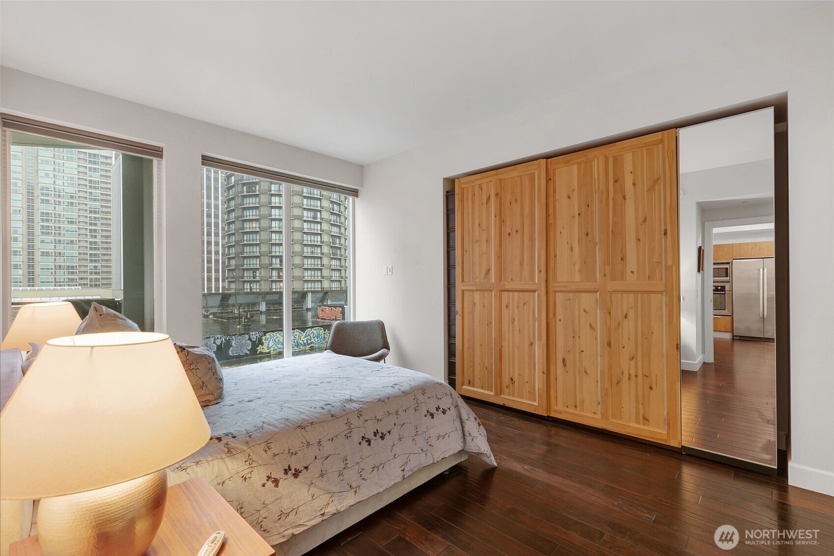 1920 4th Avenue, Unit 509 Seattle, WA 98101 - Photo 14 of 33 a bedroom with a bed and wooden floor