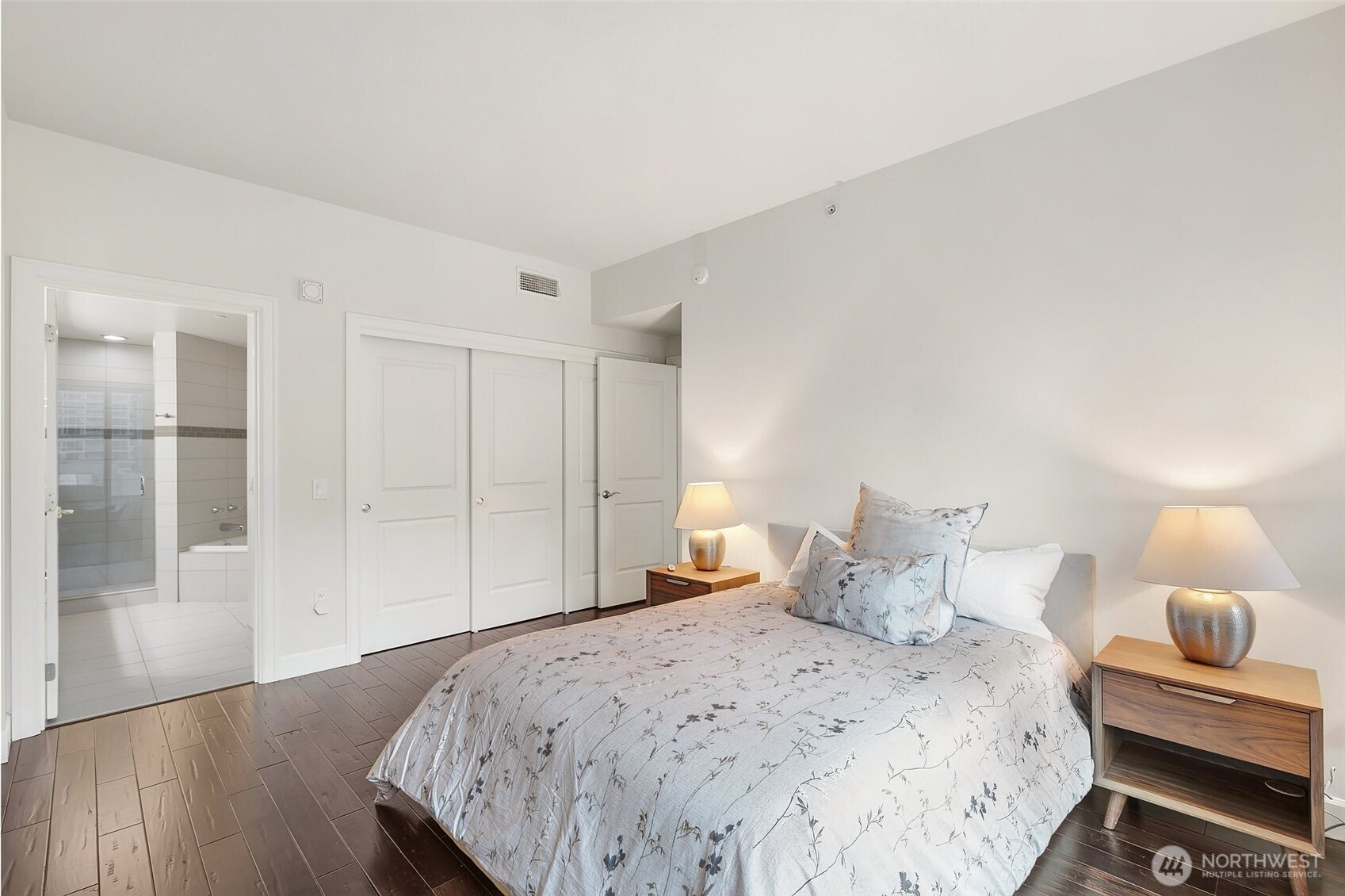 1920 4th Avenue, Unit 509 Seattle, WA 98101 - Photo 15 of 33 a bedroom with a bed and a lamp