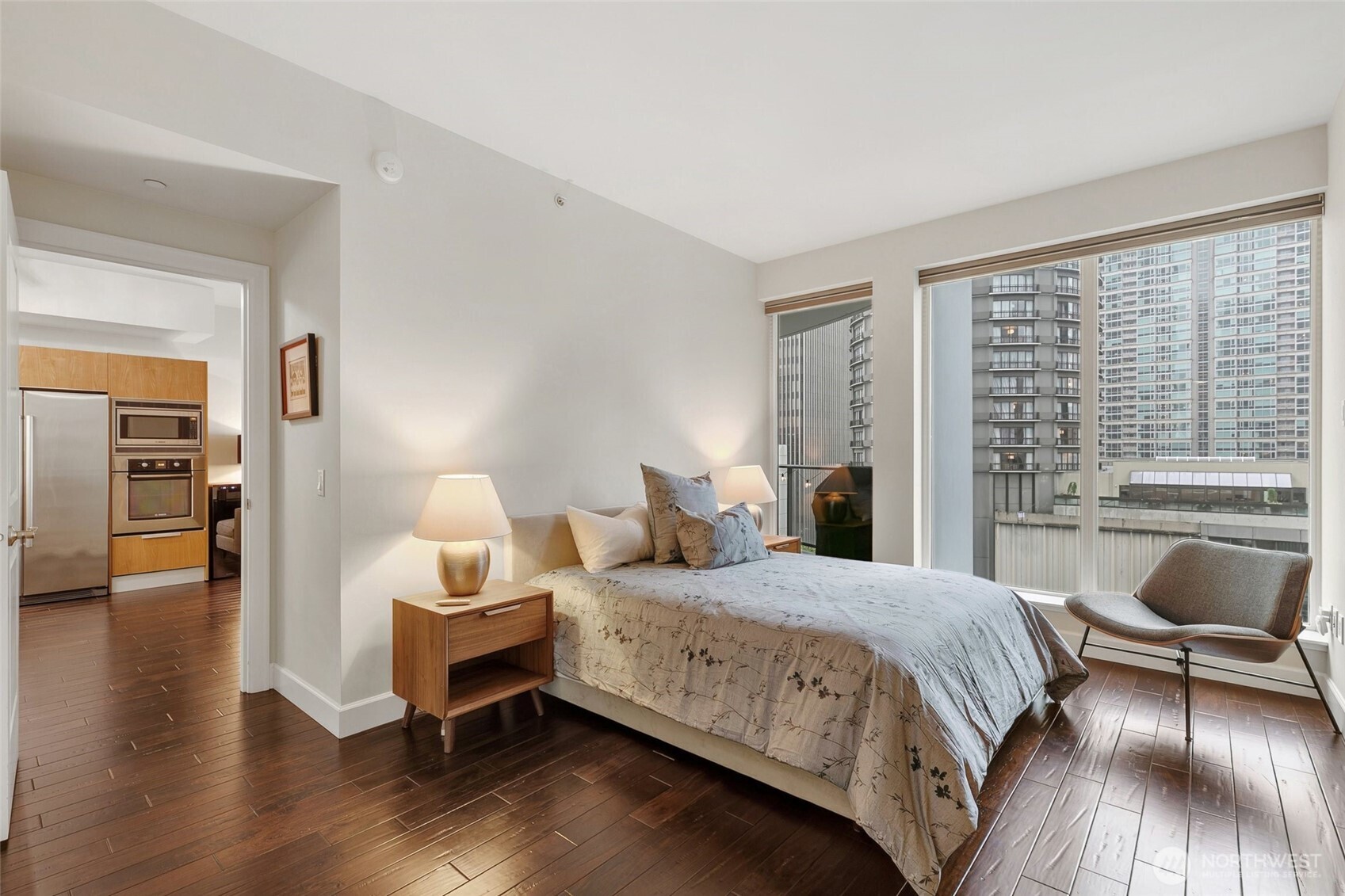 1920 4th Avenue, Unit 509 Seattle, WA 98101 - Photo 16 of 33 a bedroom with a bed and wooden floor